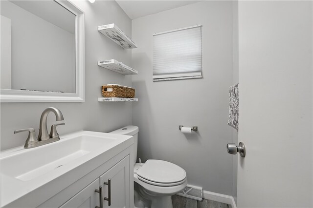 105 Canaveral Dr, Penn Hills, PA 15235 - bathroom with toilet, vanity, baseboards, and wood finished floors