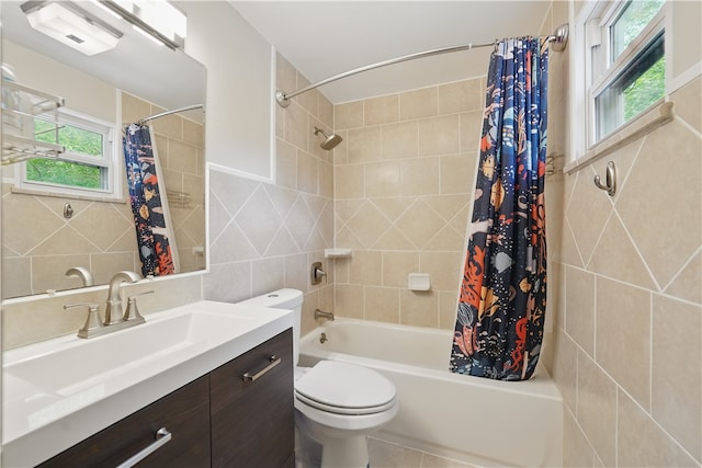 105 Canaveral Dr, Penn Hills, PA 15235 - bathroom featuring tile walls, vanity, shower / tub combo with curtain, toilet, and healthy amount of natural light