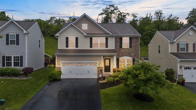 224 Long Ridge Dr, Kennedy Twp, PA 15108 - view of front facade with board and batten siding, an attached garage, asphalt driveway, stone siding, and a front lawn