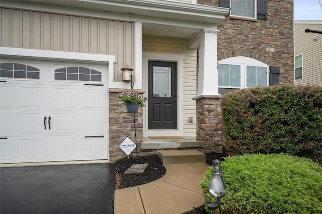 224 Long Ridge Dr, Kennedy Twp, PA 15108 - doorway to property featuring stone siding, board and batten siding, and a garage