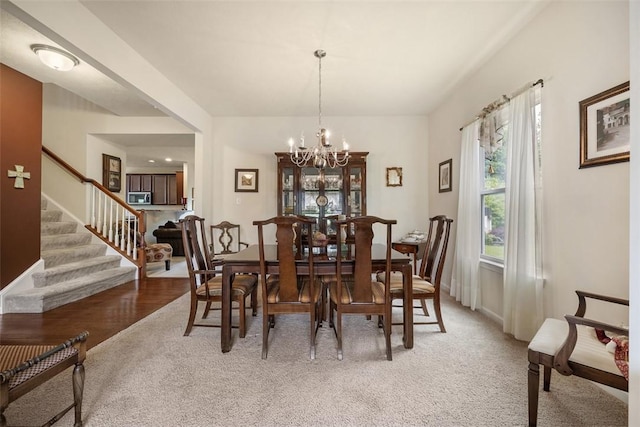 224 Long Ridge Dr, Kennedy Twp, PA 15108 - dining space with a chandelier, stairway, light carpet, and baseboards