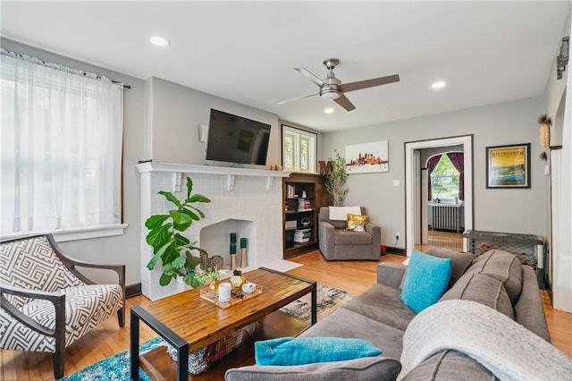 8243 High St, Mccandless, PA 15237 - living room featuring a ceiling fan, wood finished floors, a tiled fireplace, baseboards, and recessed lighting