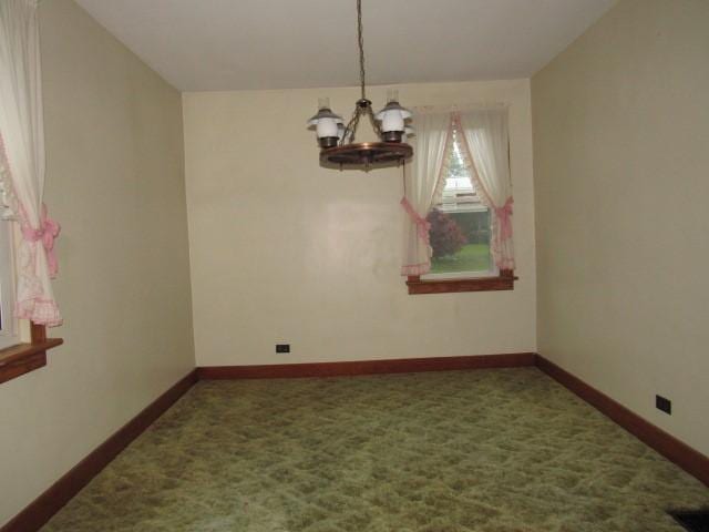 619 W Race St, Somerset Boro, PA 15501 - spare room featuring a chandelier, carpet, and baseboards