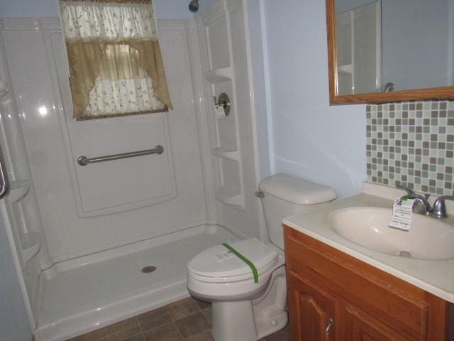 619 W Race St, Somerset Boro, PA 15501 - full bathroom with walk in shower, vanity, toilet, and tasteful backsplash