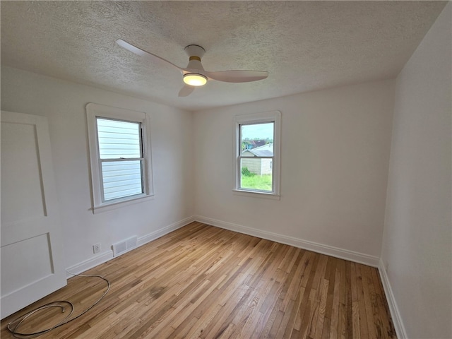 1102 Vermont Ave, White Oak, PA 15131 - unfurnished room with light wood finished floors, baseboards, ceiling fan, and a textured ceiling