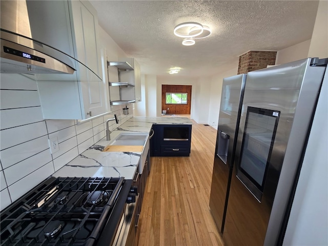 1102 Vermont Ave, White Oak, PA 15131 - kitchen with stainless steel fridge with ice dispenser, wall chimney exhaust hood, open shelves, backsplash, and a textured ceiling
