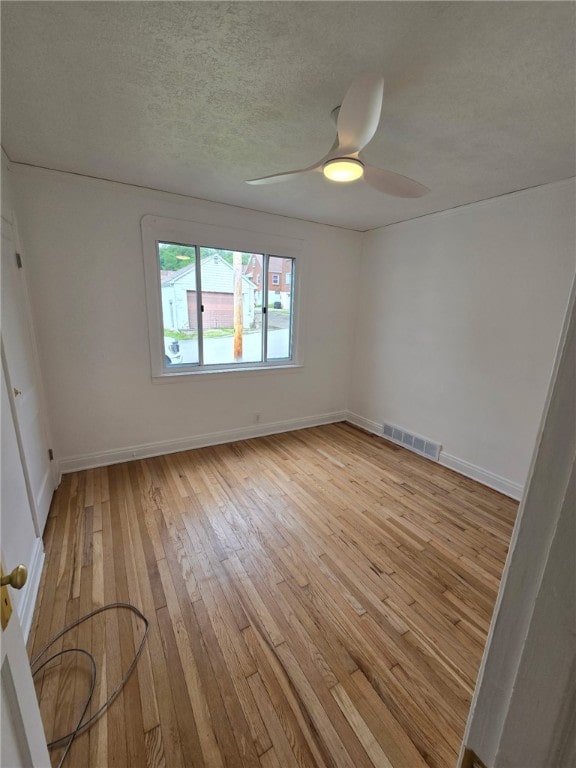 1102 Vermont Ave, White Oak, PA 15131 - unfurnished room featuring light wood-style flooring, a textured ceiling, baseboards, and ceiling fan