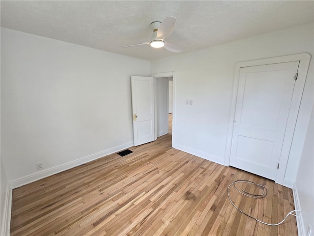 1102 Vermont Ave, White Oak, PA 15131 - unfurnished bedroom featuring light wood-type flooring, baseboards, a ceiling fan, and a textured ceiling
