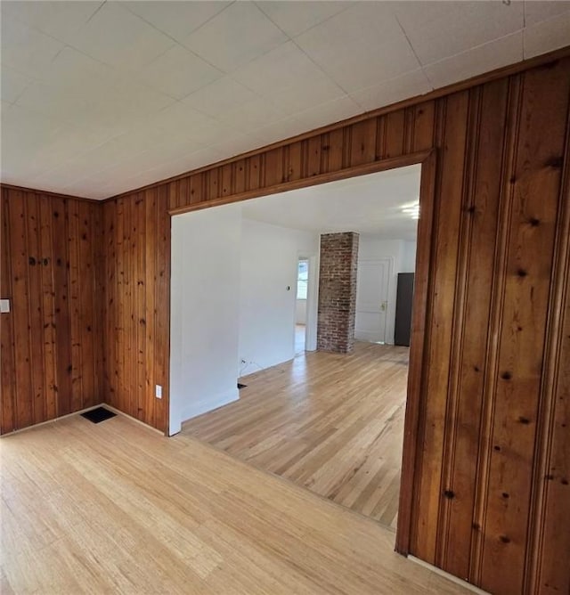 1102 Vermont Ave, White Oak, PA 15131 - unfurnished room with light wood-type flooring, wood walls, and baseboards