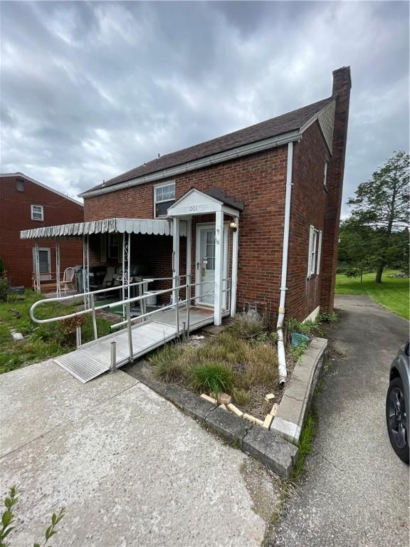 1001 Wible Run Rd, Shaler, PA 15209 - view of property featuring a chimney and brick siding
