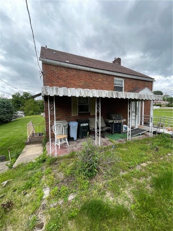 1001 Wible Run Rd, Shaler, PA 15209 - back of property featuring brick siding and a patio