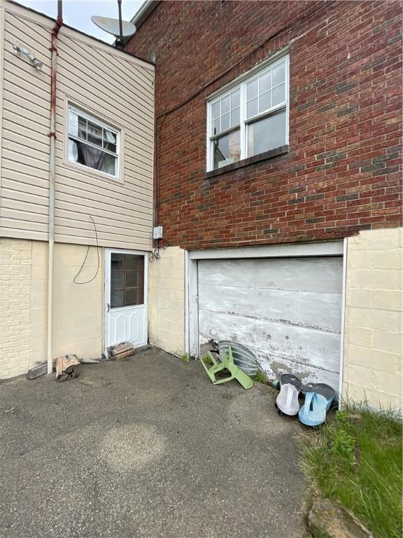 1001 Wible Run Rd, Shaler, PA 15209 - view of property exterior with an attached garage and brick siding