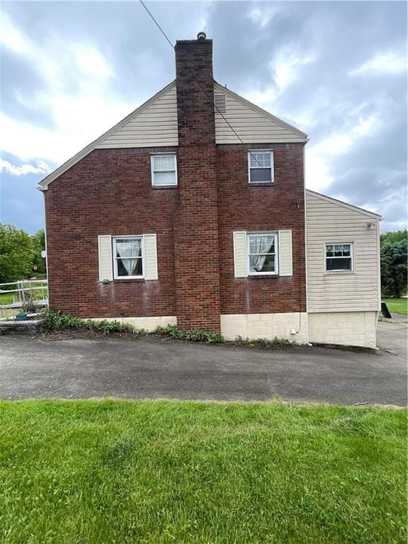 1001 Wible Run Rd, Shaler, PA 15209 - view of property exterior with a chimney, brick siding, and a lawn