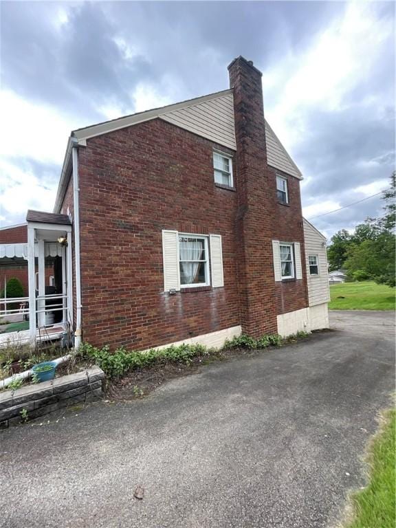 1001 Wible Run Rd, Shaler, PA 15209 - view of home's exterior with brick siding and a chimney