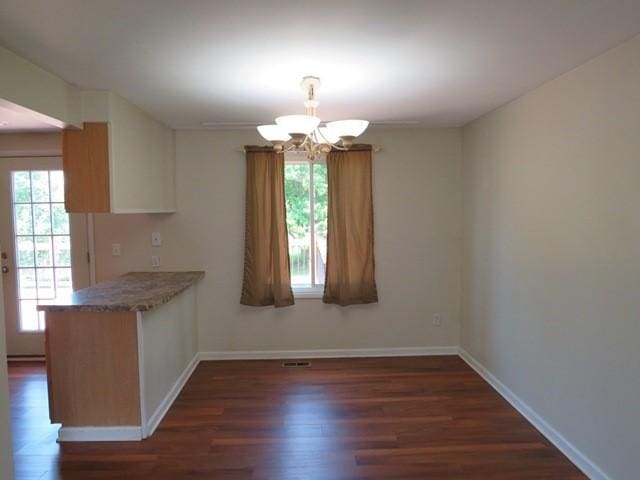 903 Fox Run Cir, Cranberry Twp, PA 16066 - unfurnished dining area featuring a chandelier, dark wood-style floors, and baseboards