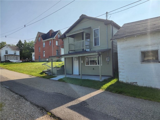 336 Fruit St, Waynsbrg/Frankln Twp, PA 15370 - view of front facade featuring a balcony, a front lawn, and a porch