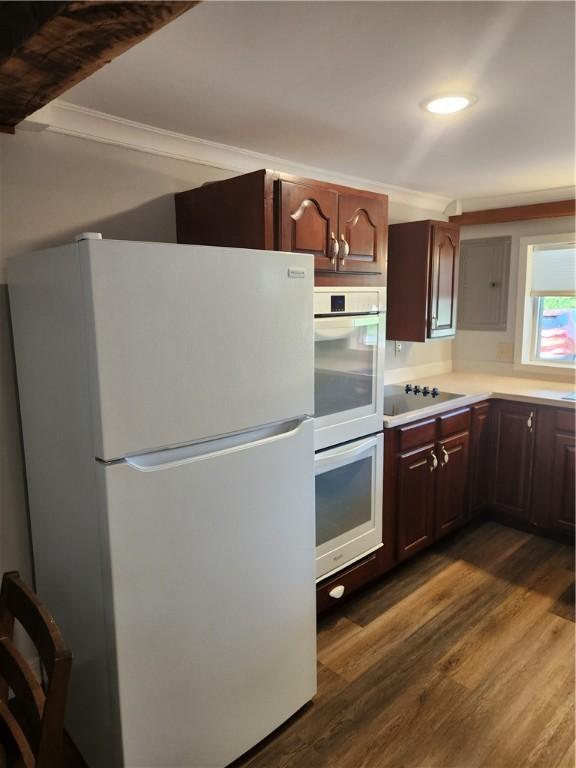 336 Fruit St, Waynsbrg/Frankln Twp, PA 15370 - kitchen with white appliances, dark wood-style flooring, ornamental molding, light countertops, and dark brown cabinets