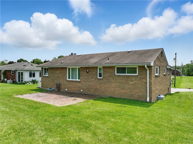 10539 Roseway Blvd, North Huntingdon, PA 15642 - rear view of property featuring a patio, brick siding, and a yard