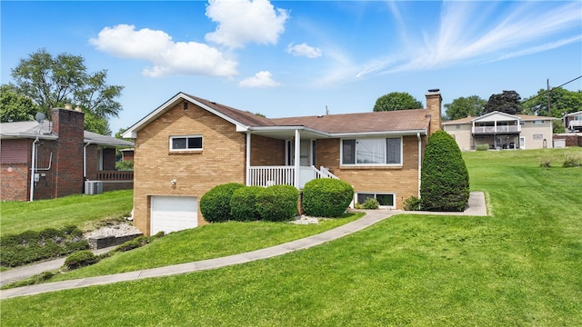 10539 Roseway Blvd, North Huntingdon, PA 15642 - view of front of home with a chimney, brick siding, a garage, a front lawn, and central AC unit