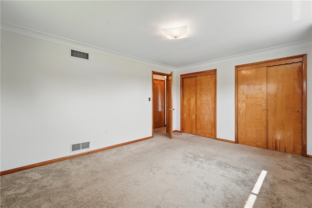 10539 Roseway Blvd, North Huntingdon, PA 15642 - unfurnished bedroom with multiple closets, light colored carpet, baseboards, and ornamental molding