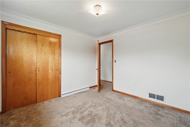 10539 Roseway Blvd, North Huntingdon, PA 15642 - unfurnished bedroom with baseboard heating, carpet floors, baseboards, crown molding, and a closet