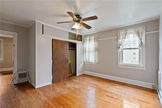 99 River Ave, Natrona, PA 15065 - unfurnished bedroom with a closet, light wood-style floors, multiple windows, ornamental molding, and a ceiling fan