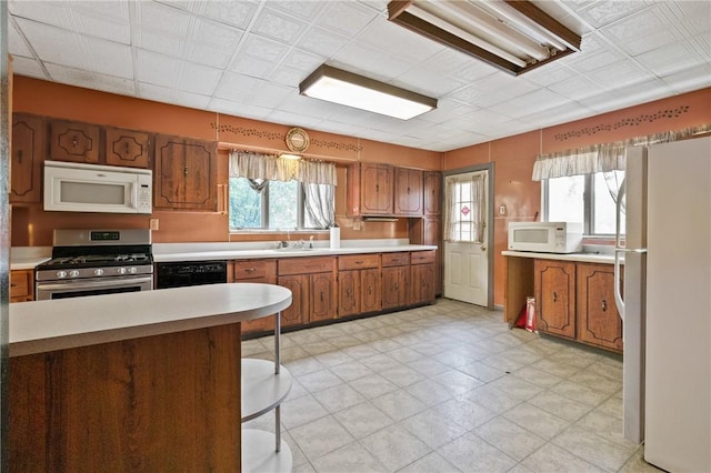 99 River Ave, Natrona, PA 15065 - kitchen featuring white appliances, brown cabinets, and light countertops