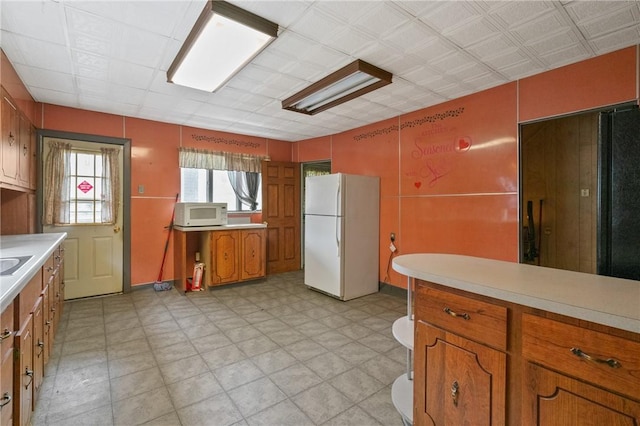 99 River Ave, Natrona, PA 15065 - kitchen featuring white appliances, brown cabinets, light floors, and light countertops
