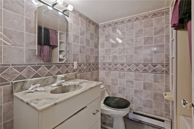 99 River Ave, Natrona, PA 15065 - bathroom featuring a baseboard radiator, tile walls, vanity, and tile patterned floors