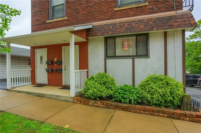 226-228 S Washington St Unit 226, City Of But Se, PA 16001 - property entrance featuring a porch, stucco siding, and roof with shingles