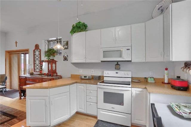 226-228 S Washington St Unit 226, City Of But Se, PA 16001 - kitchen with white appliances, a peninsula, light countertops, and white cabinets