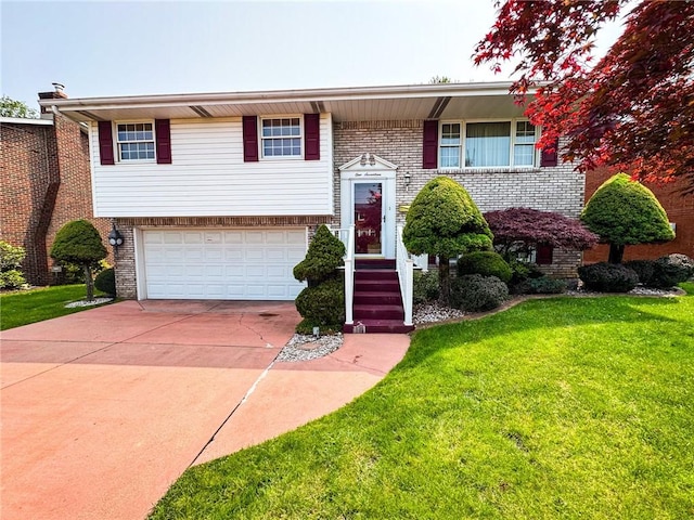 117 Harphen St, Versailles Boro, PA 15132 - bi-level home featuring a garage, brick siding, and a front lawn