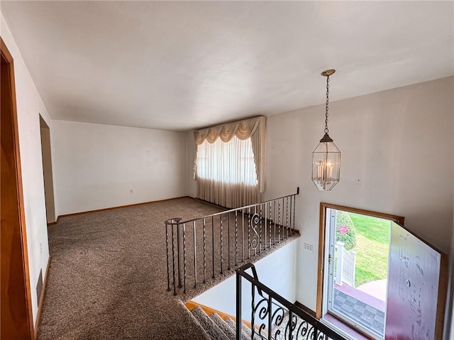 117 Harphen St, Versailles Boro, PA 15132 - staircase with a chandelier, carpet floors, and baseboards