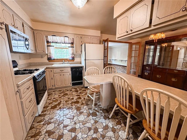 117 Harphen St, Versailles Boro, PA 15132 - kitchen with stainless steel microwave, black dishwasher, gas range oven, stone finish flooring, and light countertops