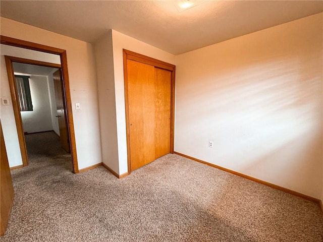 117 Harphen St, Versailles Boro, PA 15132 - unfurnished bedroom with baseboards, carpet flooring, and a closet