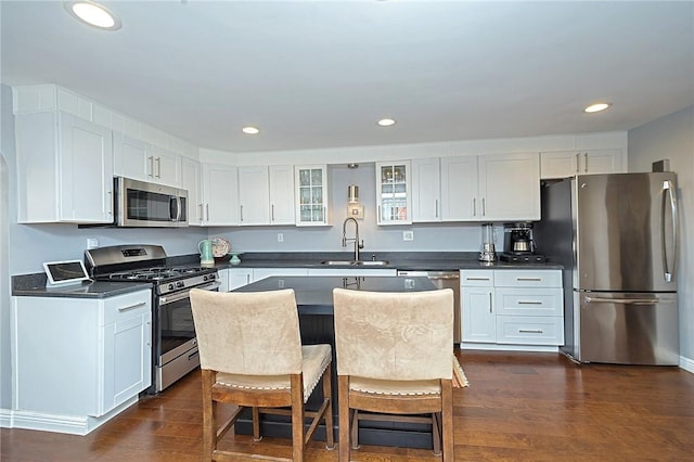 1921 Jane St, South Side, PA 15203 - kitchen with appliances with stainless steel finishes, a sink, dark wood-style floors, glass insert cabinets, and dark countertops