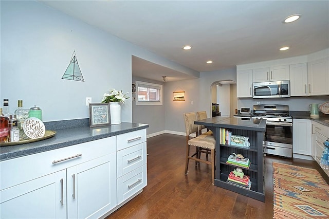 1921 Jane St, South Side, PA 15203 - kitchen featuring stainless steel appliances, arched walkways, dark countertops, white cabinetry, and recessed lighting