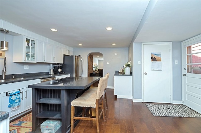1921 Jane St, South Side, PA 15203 - kitchen with arched walkways, freestanding refrigerator, dark countertops, white cabinets, and glass insert cabinets