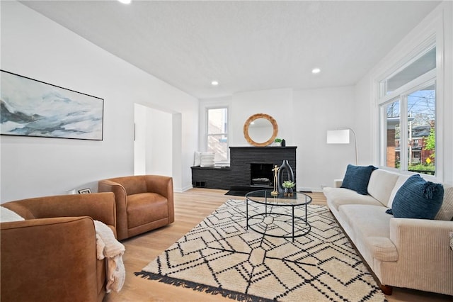 220 Dewey St, Edgewood, PA 15218 - living area with healthy amount of natural light, recessed lighting, light wood-style floors, a brick fireplace, and baseboards