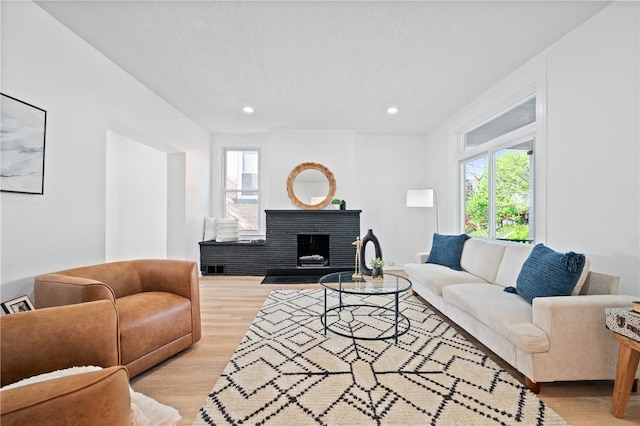 220 Dewey St, Edgewood, PA 15218 - living room with light wood-style floors, a fireplace, and recessed lighting