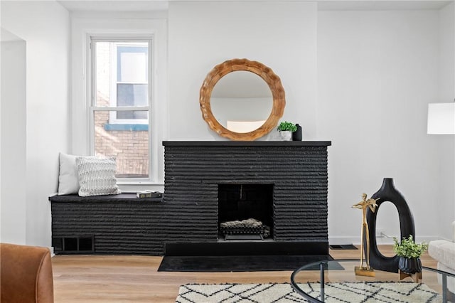 220 Dewey St, Edgewood, PA 15218 - detailed view of wood finished floors and a fireplace with flush hearth