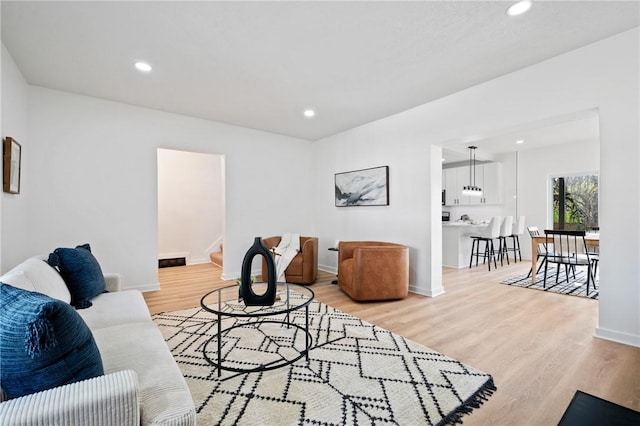 220 Dewey St, Edgewood, PA 15218 - living area featuring light wood finished floors, recessed lighting, stairs, and baseboards