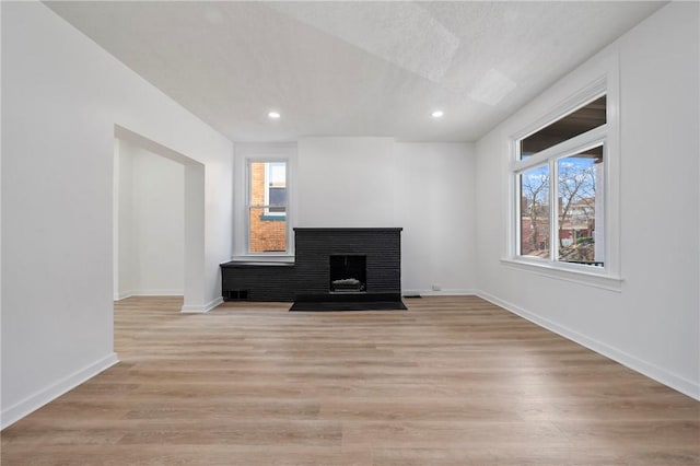 220 Dewey St, Edgewood, PA 15218 - unfurnished living room featuring a fireplace with flush hearth, light wood-style floors, baseboards, and recessed lighting