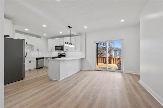 220 Dewey St, Edgewood, PA 15218 - kitchen with appliances with stainless steel finishes, baseboards, light wood-style flooring, light countertops, and recessed lighting