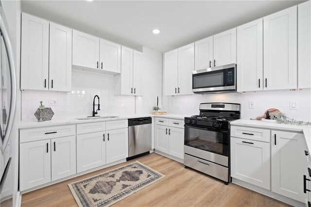 220 Dewey St, Edgewood, PA 15218 - kitchen featuring appliances with stainless steel finishes, a sink, white cabinetry, light countertops, and recessed lighting