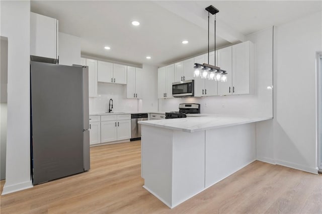 220 Dewey St, Edgewood, PA 15218 - kitchen featuring appliances with stainless steel finishes, a sink, a peninsula, light wood-style floors, and recessed lighting