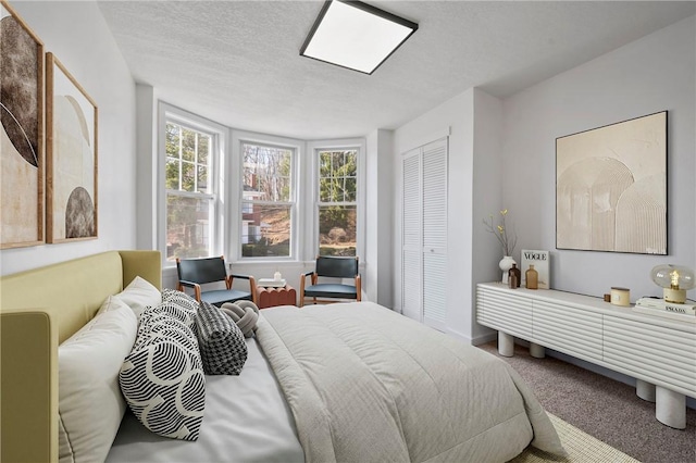 220 Dewey St, Edgewood, PA 15218 - carpeted bedroom with a textured ceiling and a closet