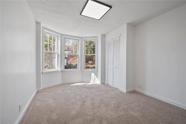 220 Dewey St, Edgewood, PA 15218 - unfurnished bedroom with carpet flooring, baseboards, a textured ceiling, and a closet