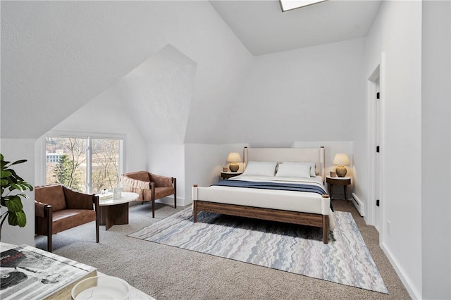 220 Dewey St, Edgewood, PA 15218 - bedroom featuring carpet floors, baseboard heating, baseboards, and vaulted ceiling