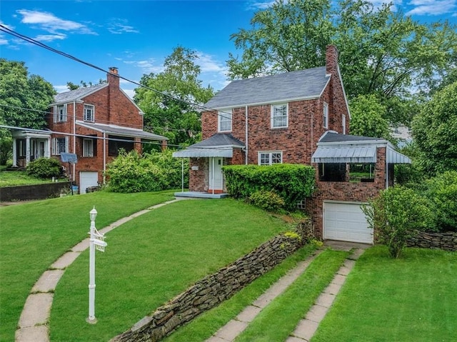 142 Slater Dr, Pleasant Hills, PA 15236 - view of front of property featuring driveway, an attached garage, brick siding, a front yard, and a chimney